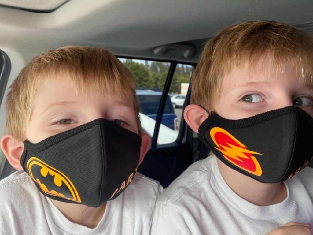 boys wearing black face masks decorated with vinyl