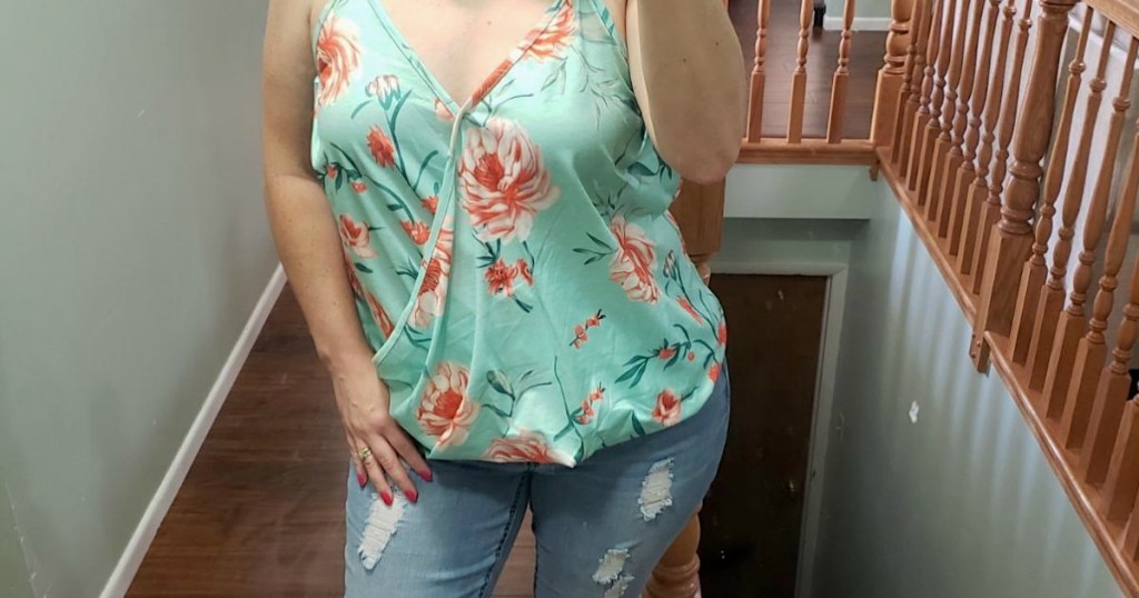 woman wearing floral tank top and jeans 