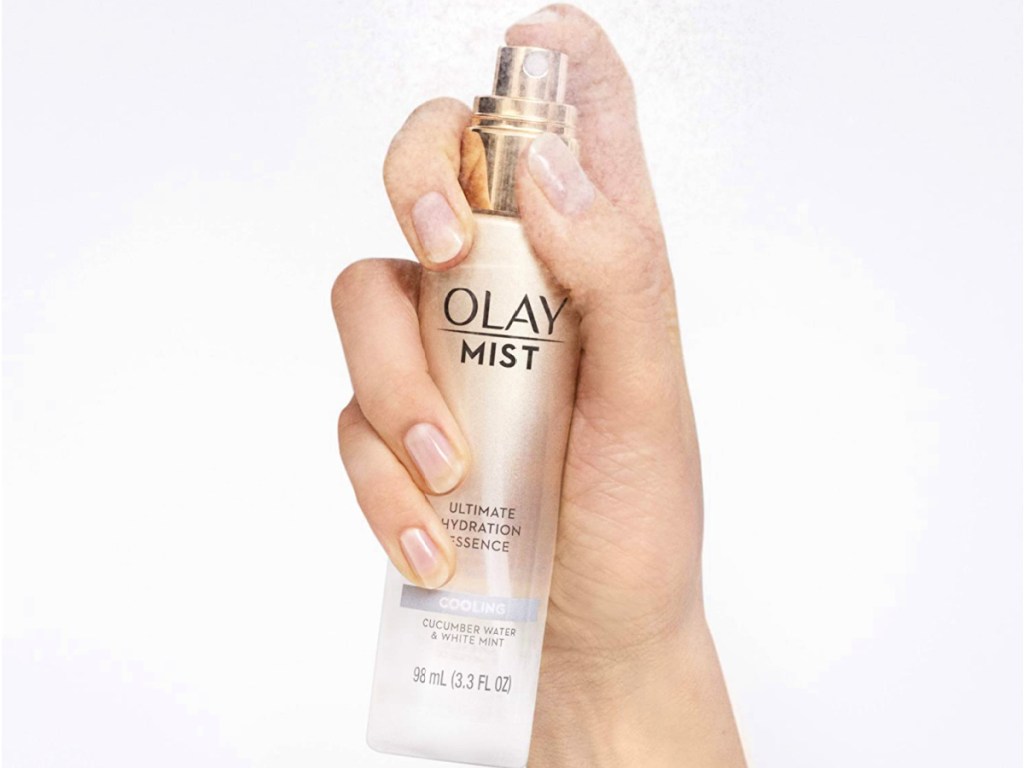 hand holding Olay Mist Ultimate Hydration Essence w/ Cucumber Water & White Mint