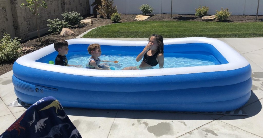 3 kids inside inflatable pool