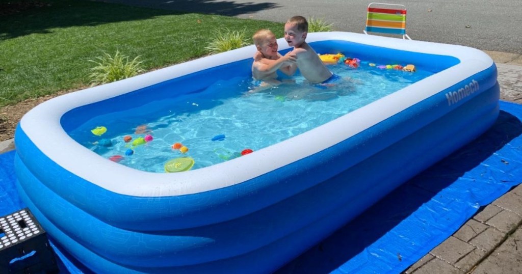 2 boys swimming in inflatable pool