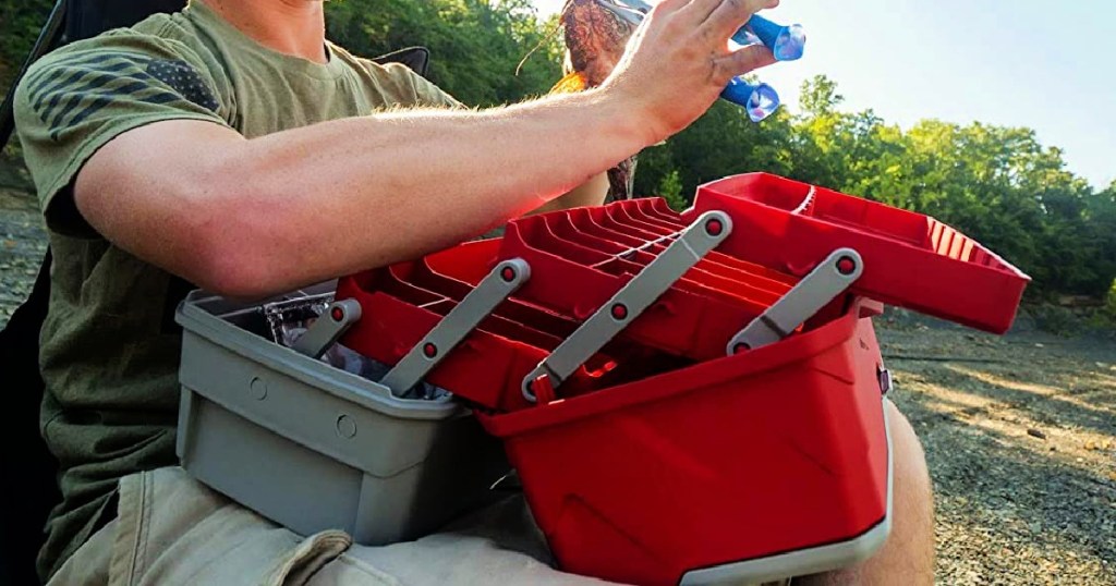 man holding a Flambeau Outdoors 3-Tray Tackle Box in Red