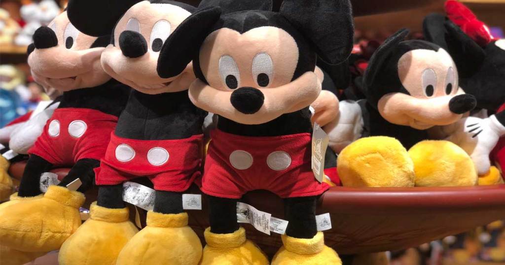 mickey mouse plush sitting on a cart