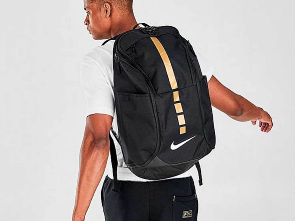 man wearing a black and gold backpack on his back