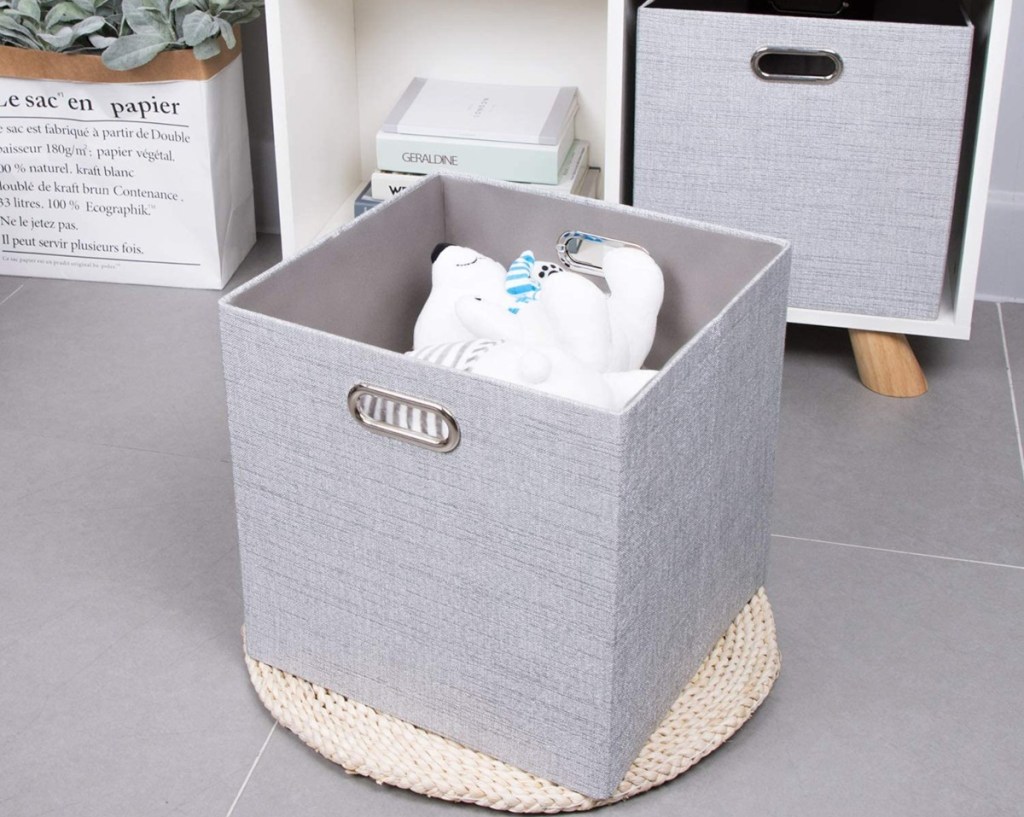 foldable gray storage bin with a teddy bear inside 