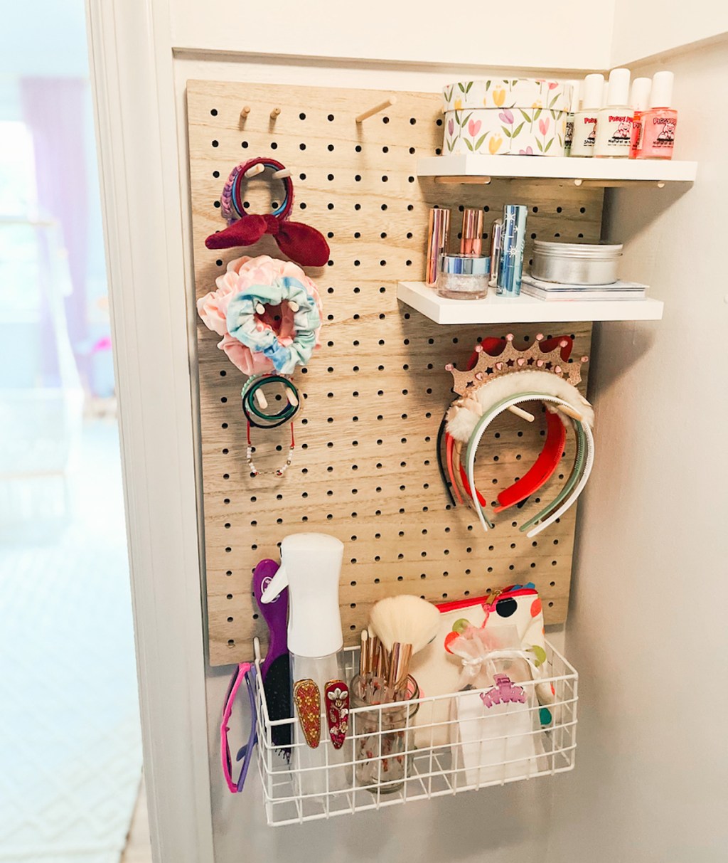 wood pegboard kids closet organization on wall with accessories 