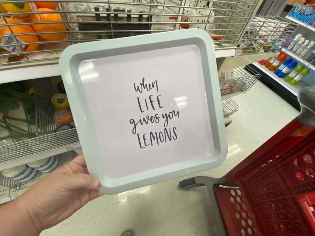 hand holding metal tray with cute saying