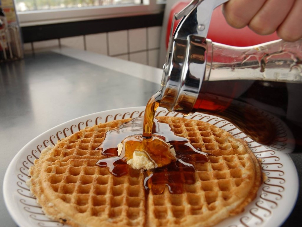 syrup being poured on a waffle at Waffle House