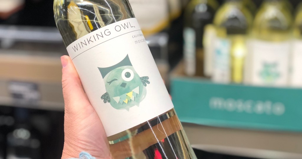 hand holding bottle of winking owl moscato