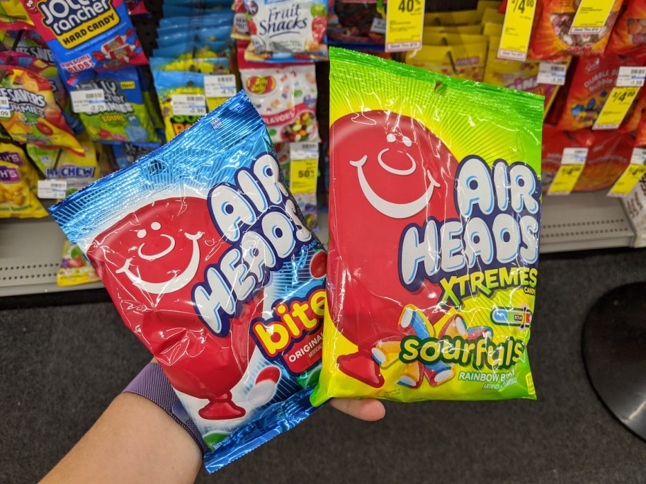 hand holding two packages of Airheads