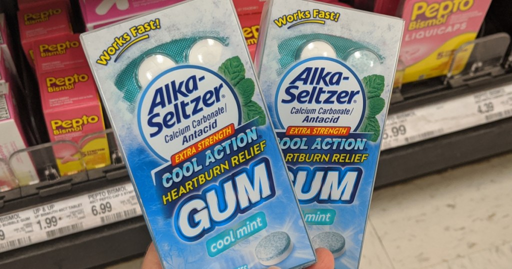 hand holding 2 packages of alka-Seltzer gum