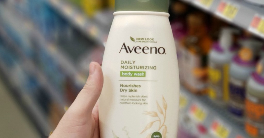 hand holding bottle of Aveeno Daily Moisturizing