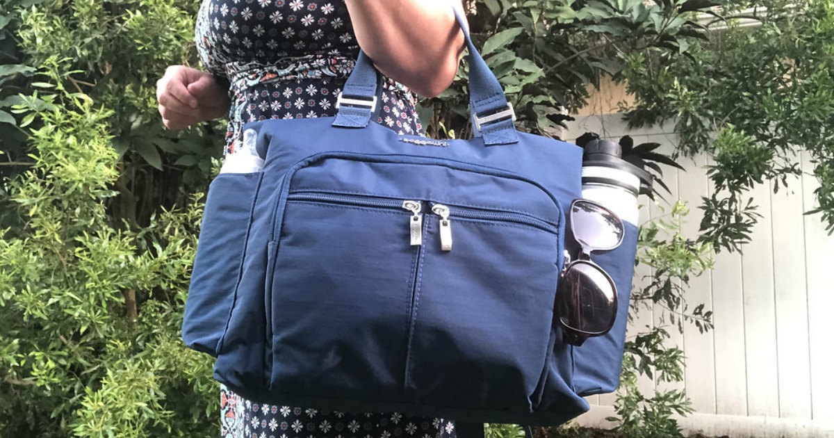 lady holding a blue Baggallini Bag 