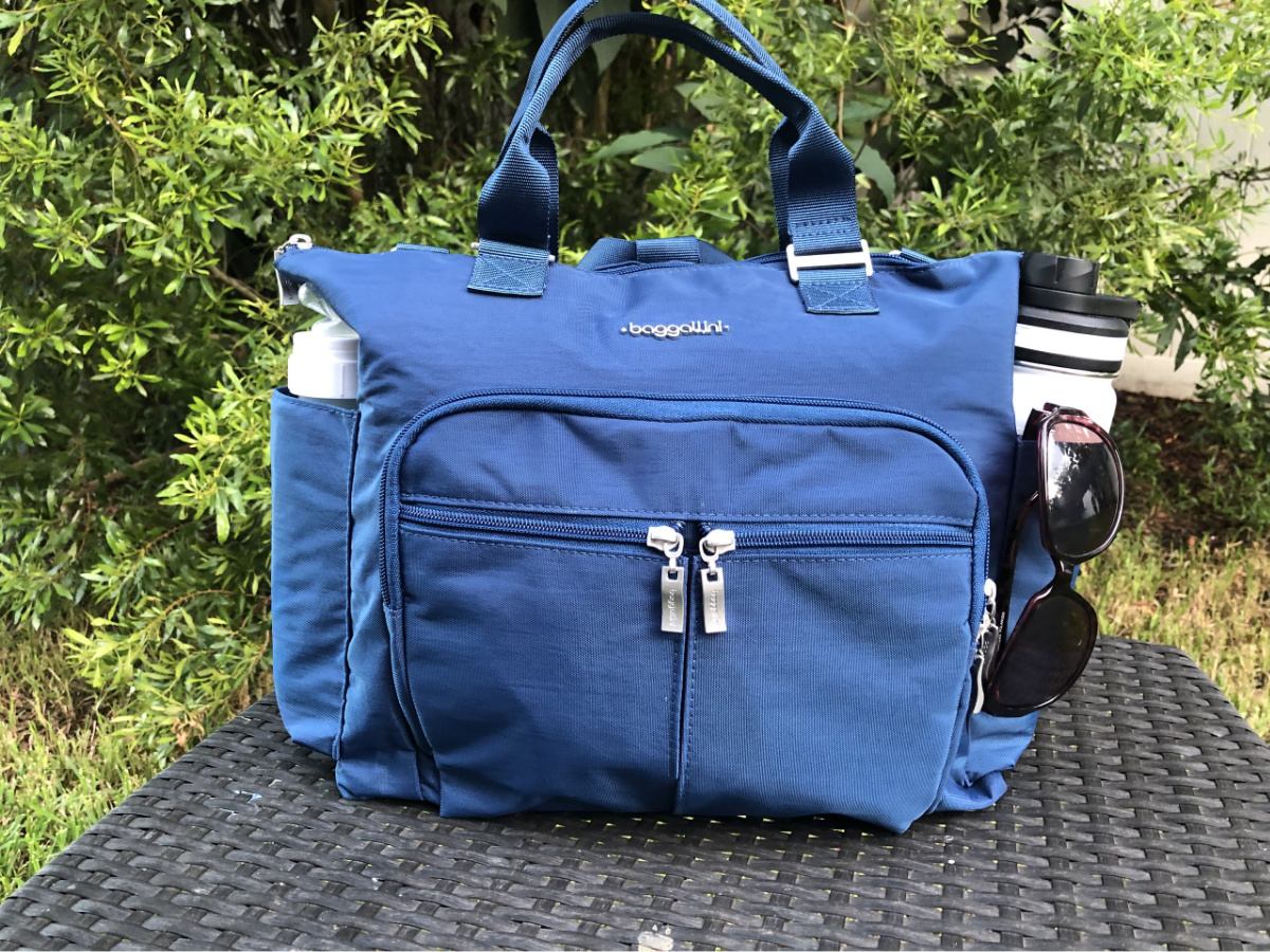 blue Baggallini bag on table outdoors