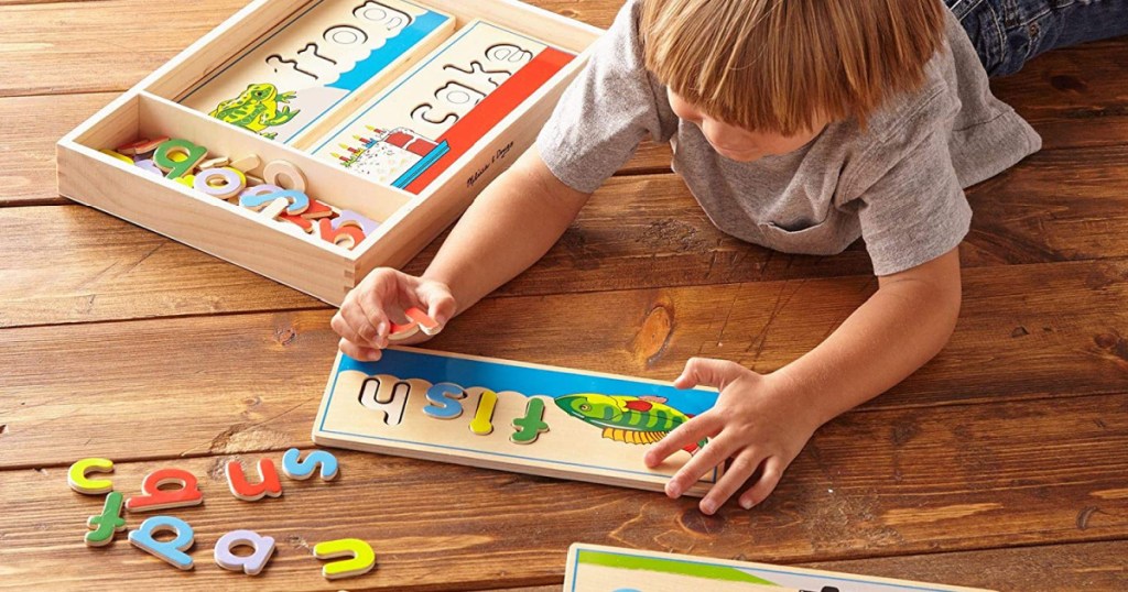 melissa and doug see and spell puzzle with little boy on floor