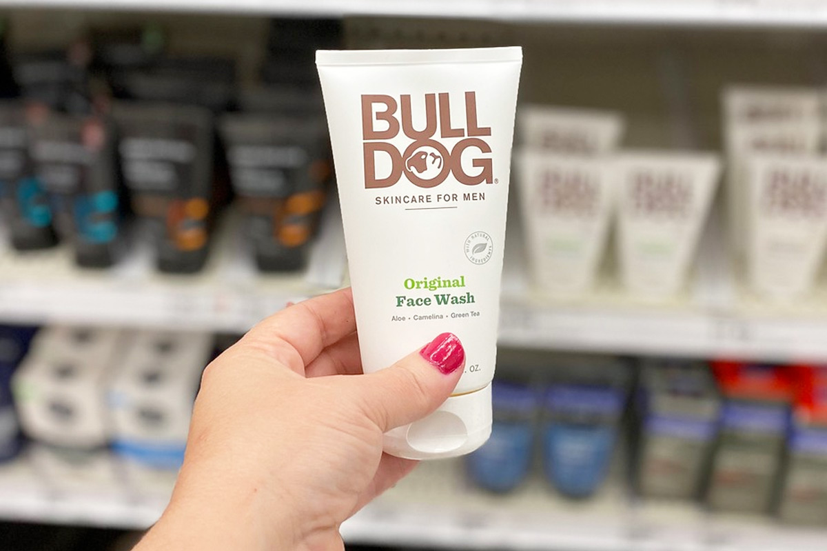 woman with pink finger nails holding up white tube of Bulldog Face Wash at Target