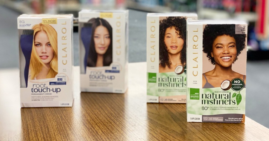 four white boxes of Clairol Hair Color on a wood table