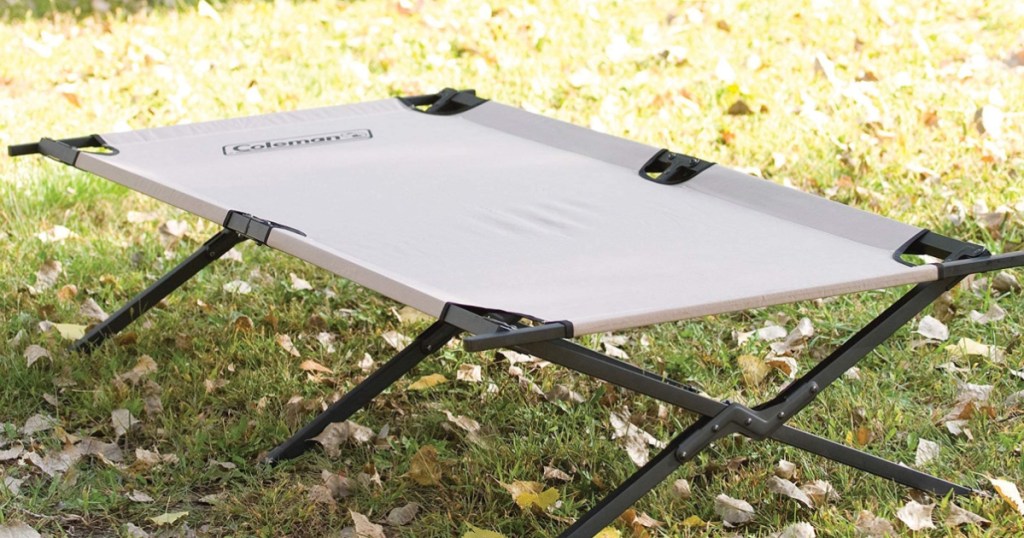 Coleman Brand Foldable Cot sitting outside on the grass