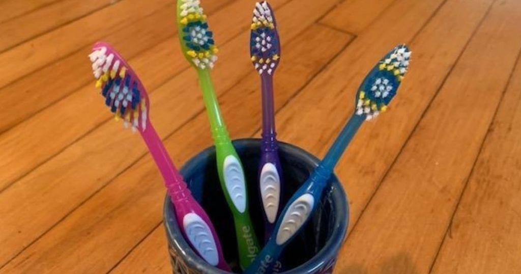 four toothbrushes in a cup