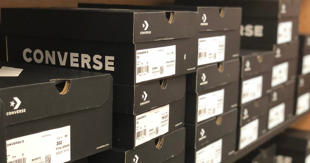 black and white shoe boxes stacked on store shelves