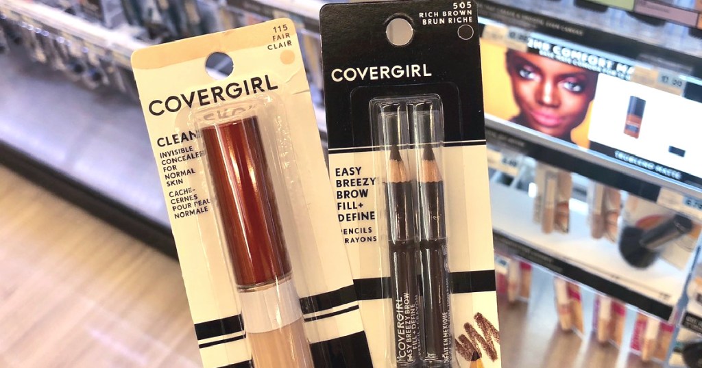 hand holding covergirl concealer and eyebrow pencils
