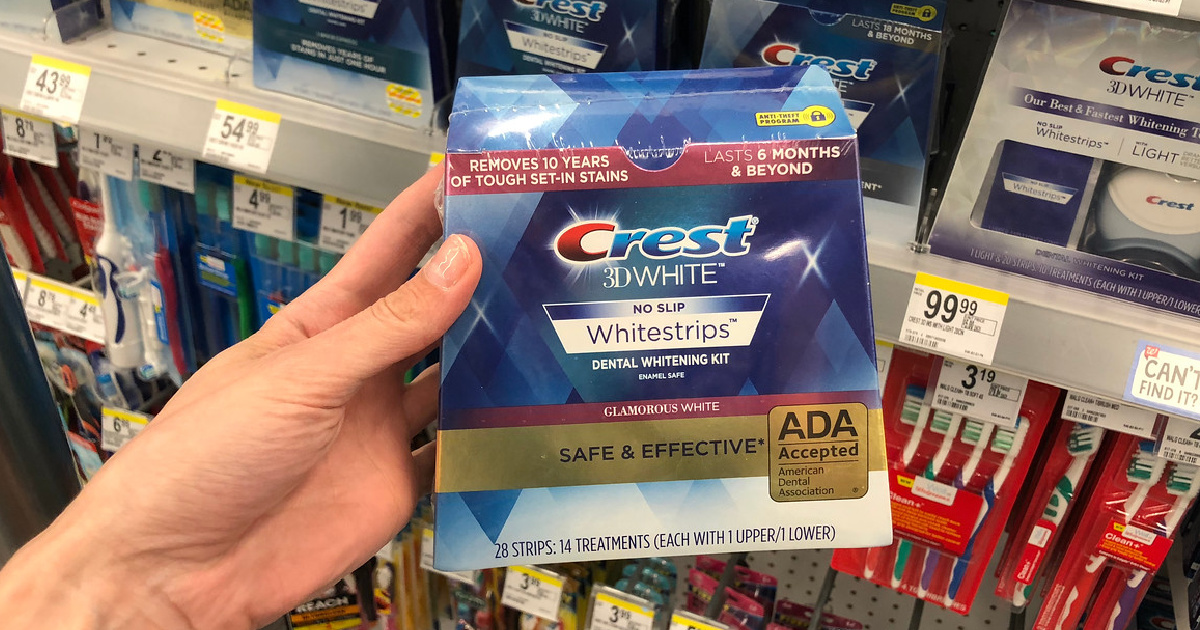 hand holding box of teeth whitening strips in store