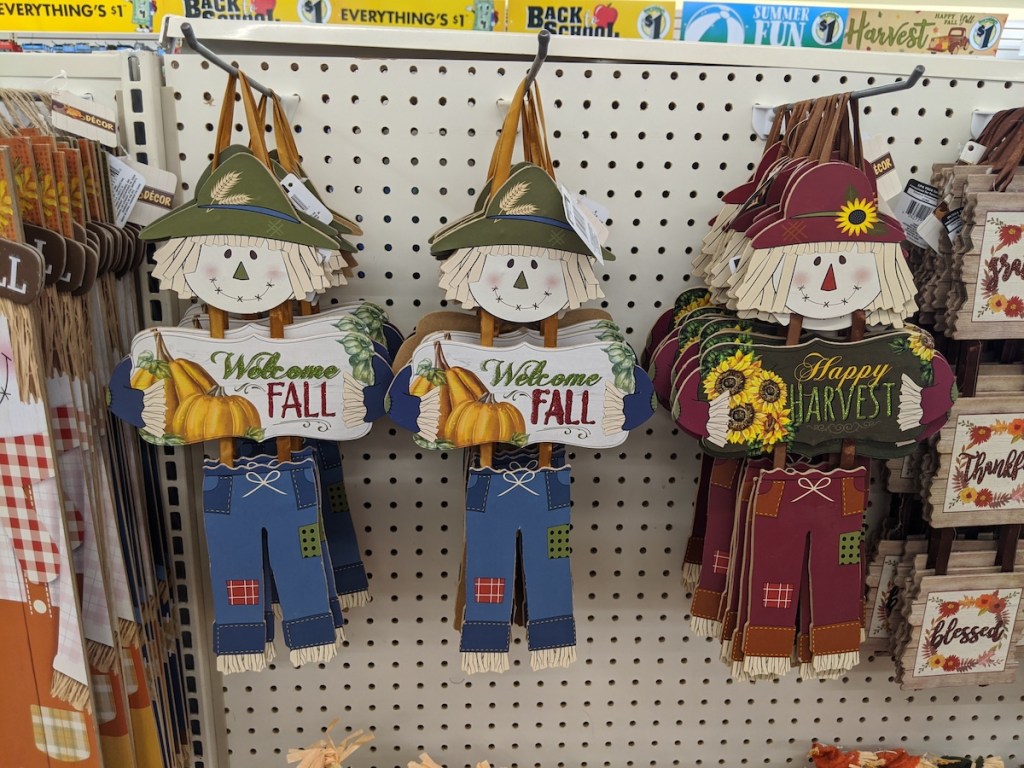three Dangling Scarecrow Welcome Signs hanging at dollar tree