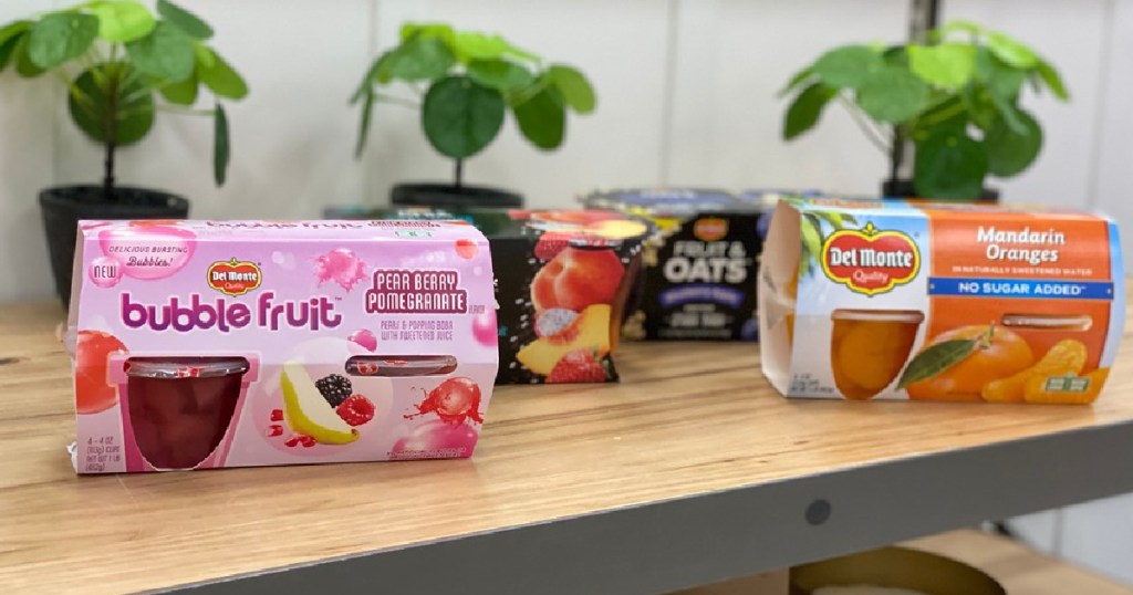 fruit cup snacks on wooden counter with small plants