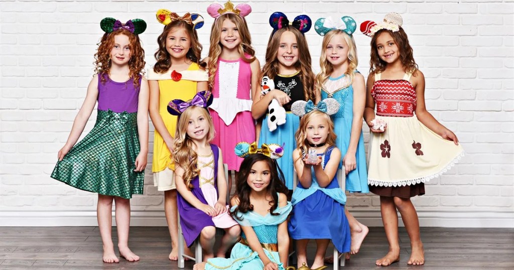 girls posing in Disney-inspired dresses