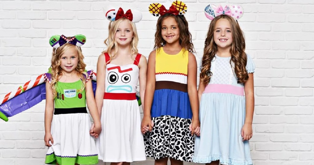 girls posing in Disney-inspired dresses