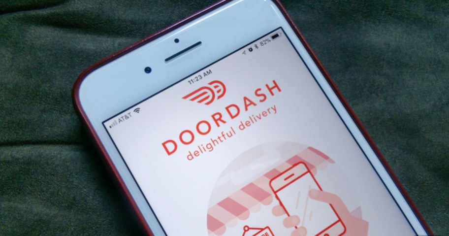 phone with food delivery service app open in order to find a DoorDash promo code or deal