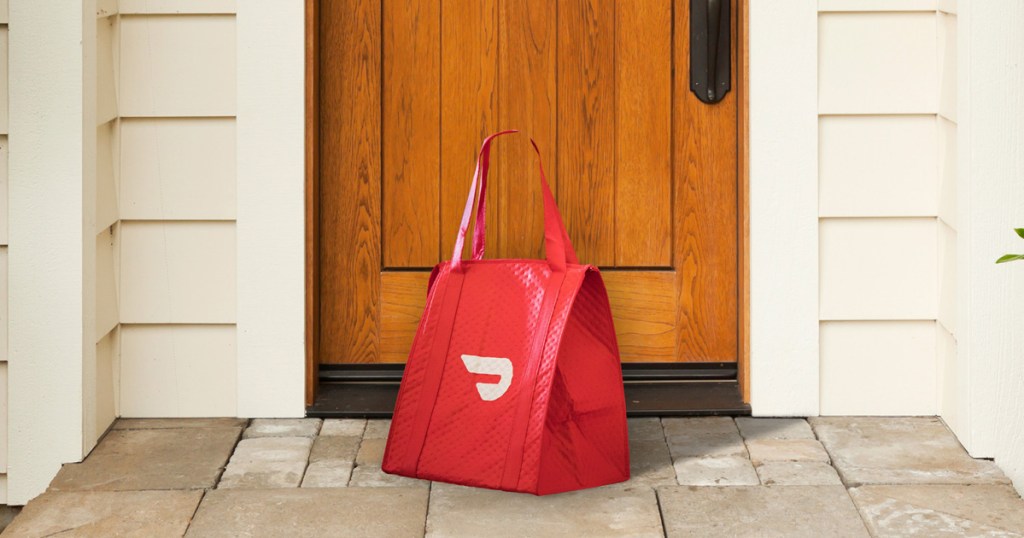 red food delivery service bag in front of home's front door