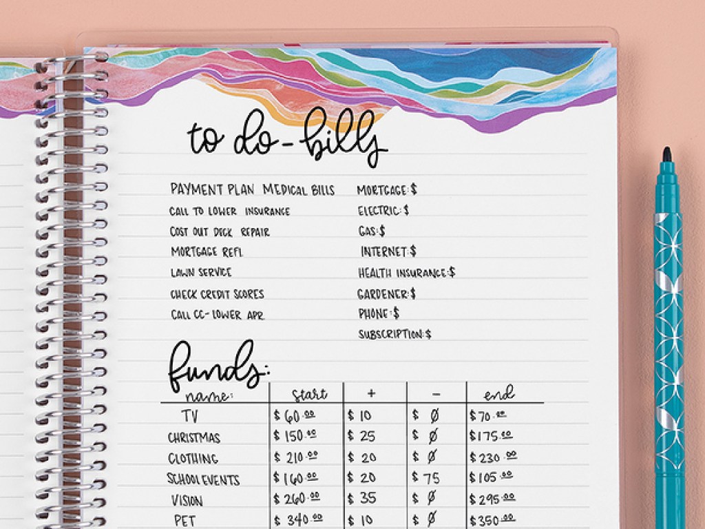 Erin Condren notebook open with writing next to a marker