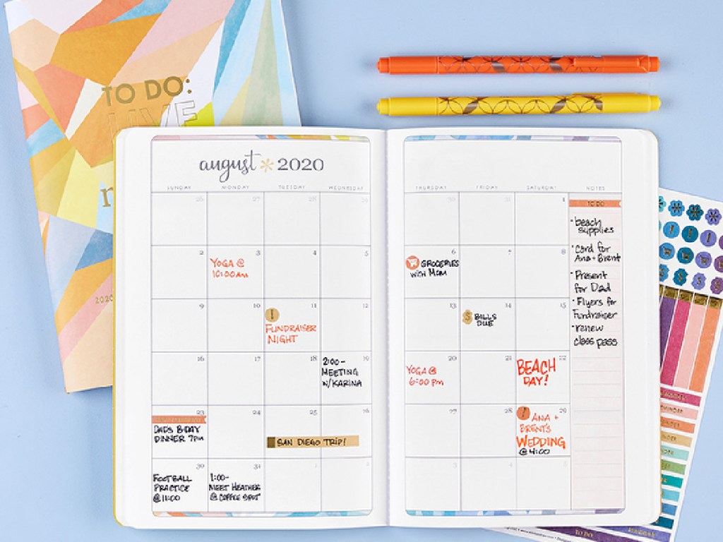 erin Condren Petite Planner open with pens and stickers