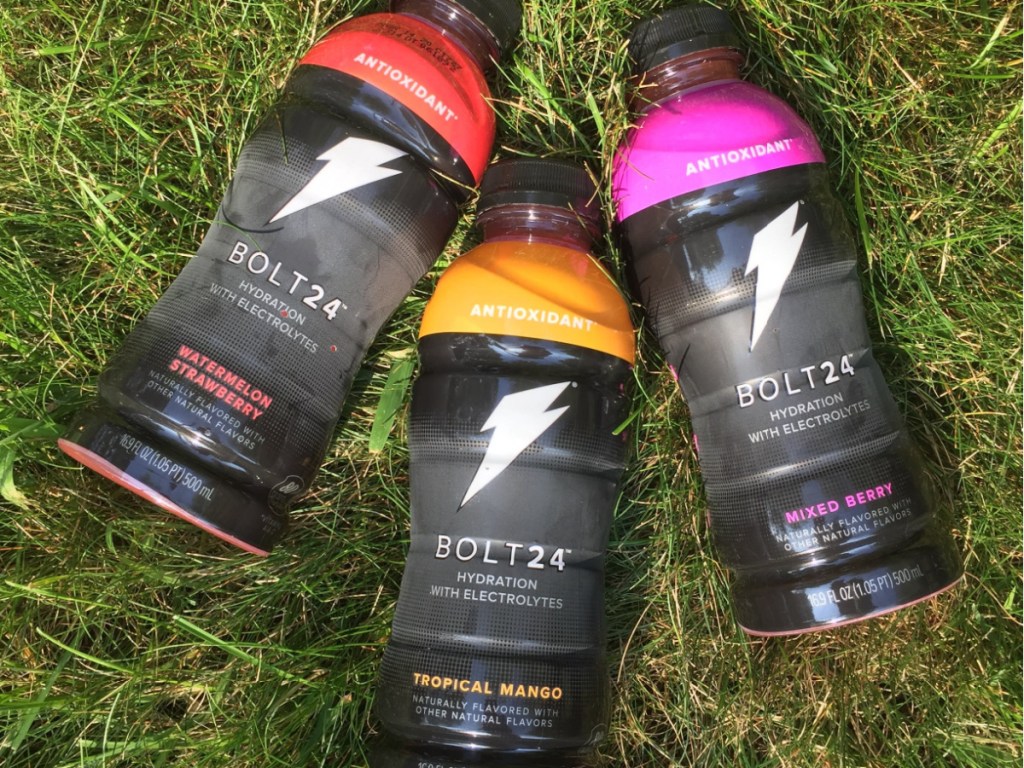 three different flavored sports laying in grass