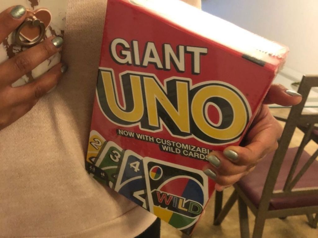 woman holding giant uno deck