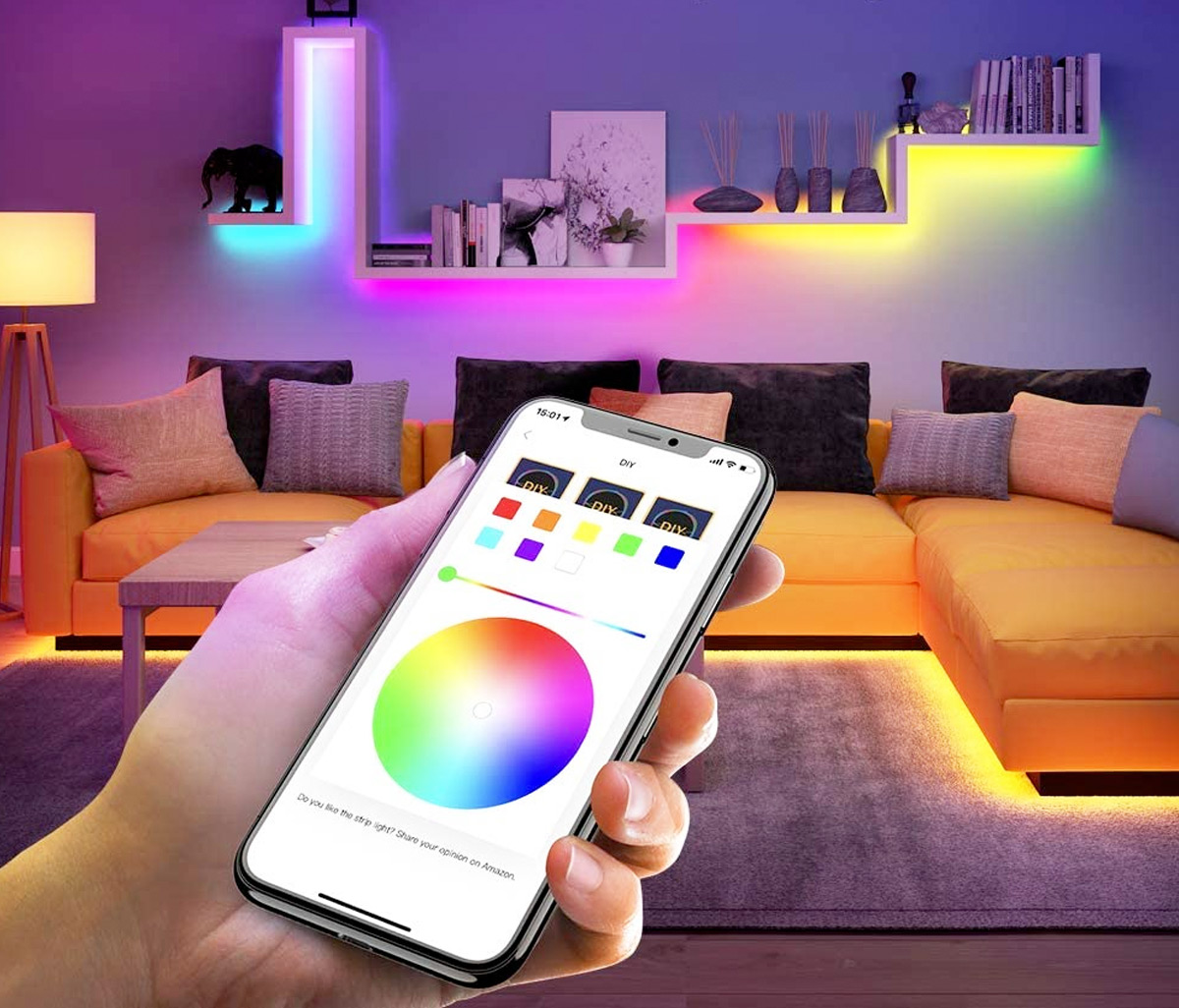 person holding smart phone with color changing app to control the rainbow led lights within the room behind them