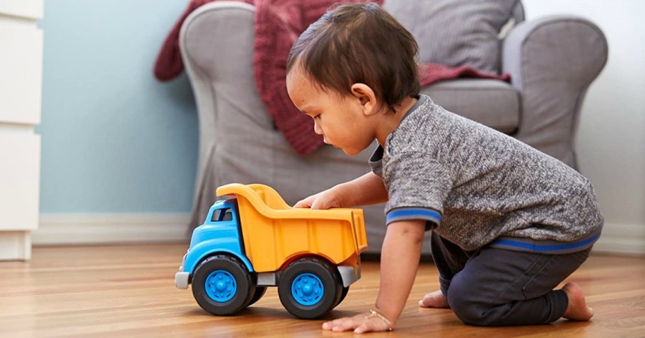 child playing with a toy dump truck