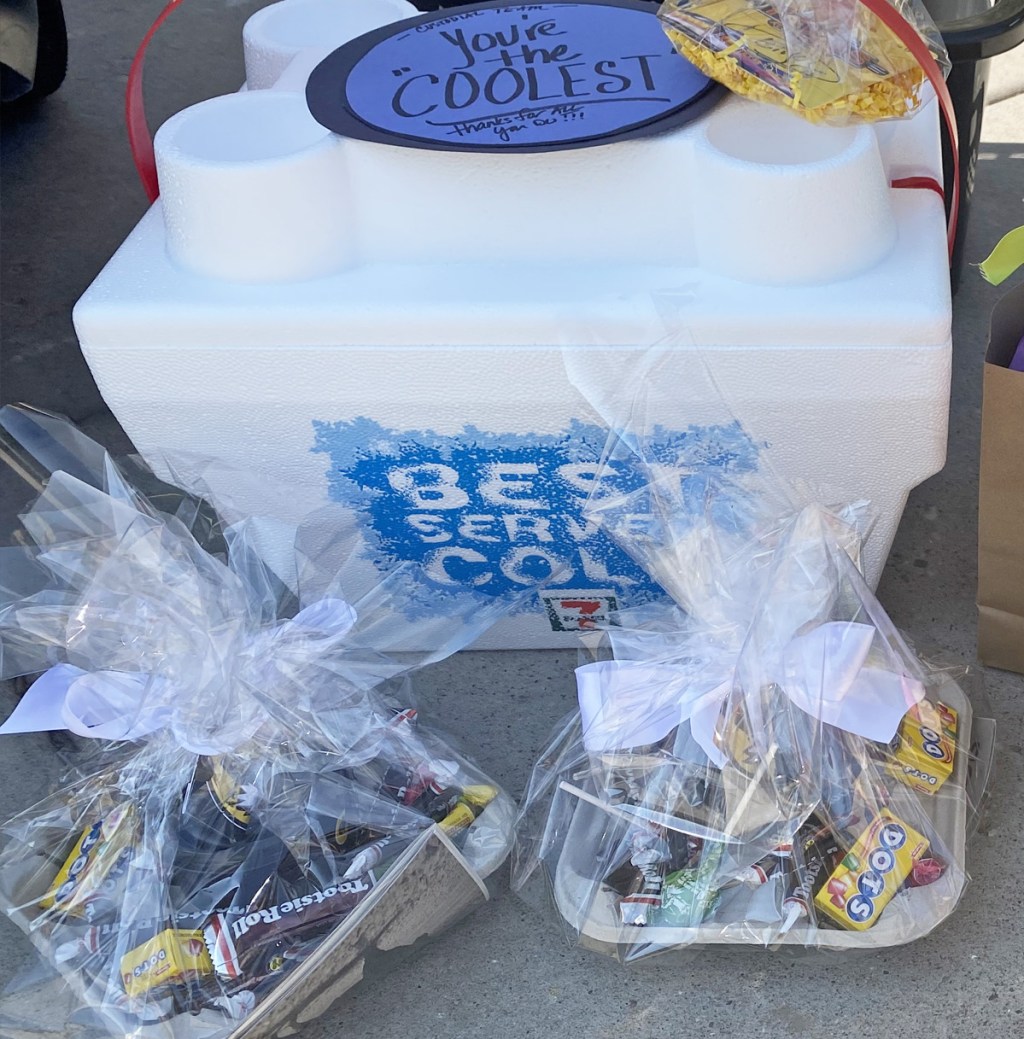 white cooler with sign that says "you are the coolest" and two gift bags filled with candy