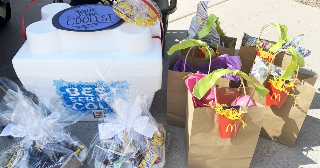 gift bags, cooler, and cellophane bags full of candy and gift cards
