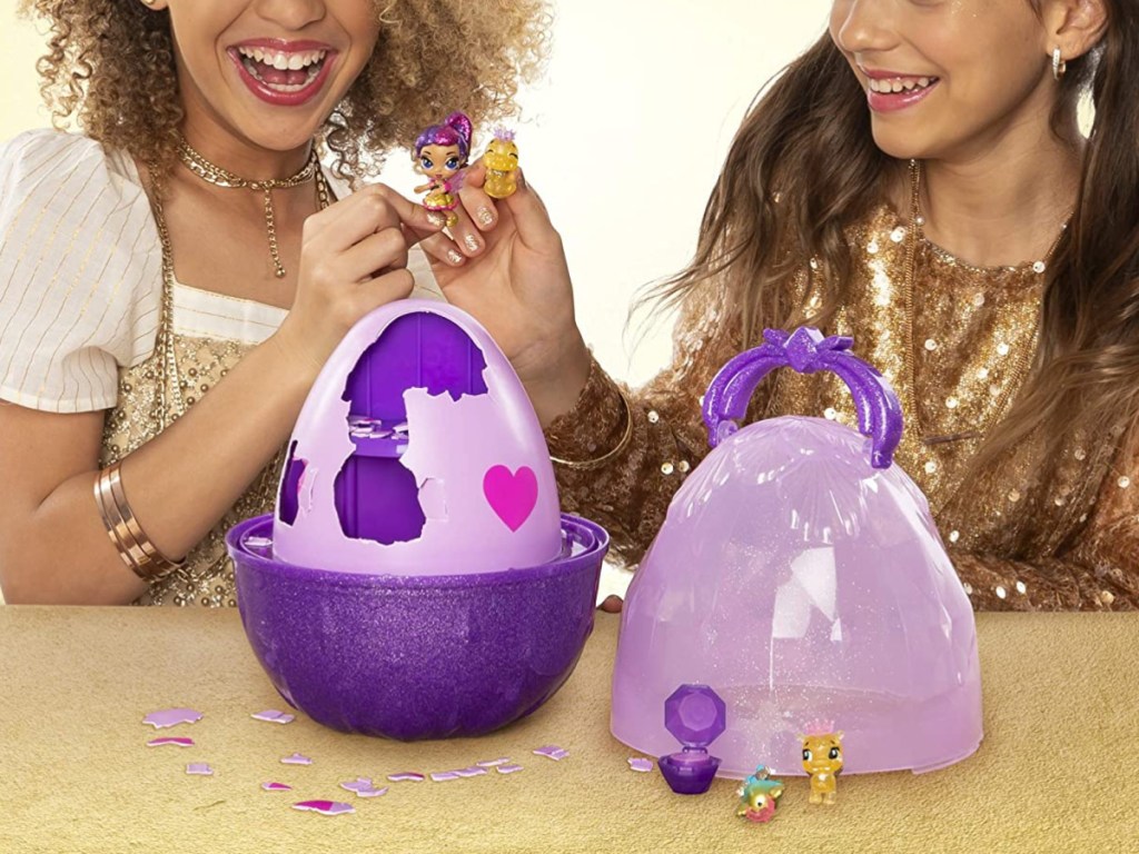 two girls playing with egg toy