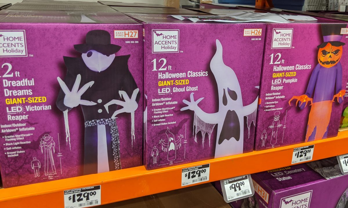 boxes of various Halloween inflatables on store shelf