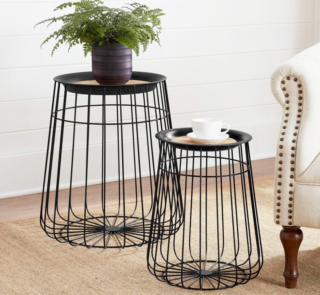 two black metal storage basket tables with wood lids