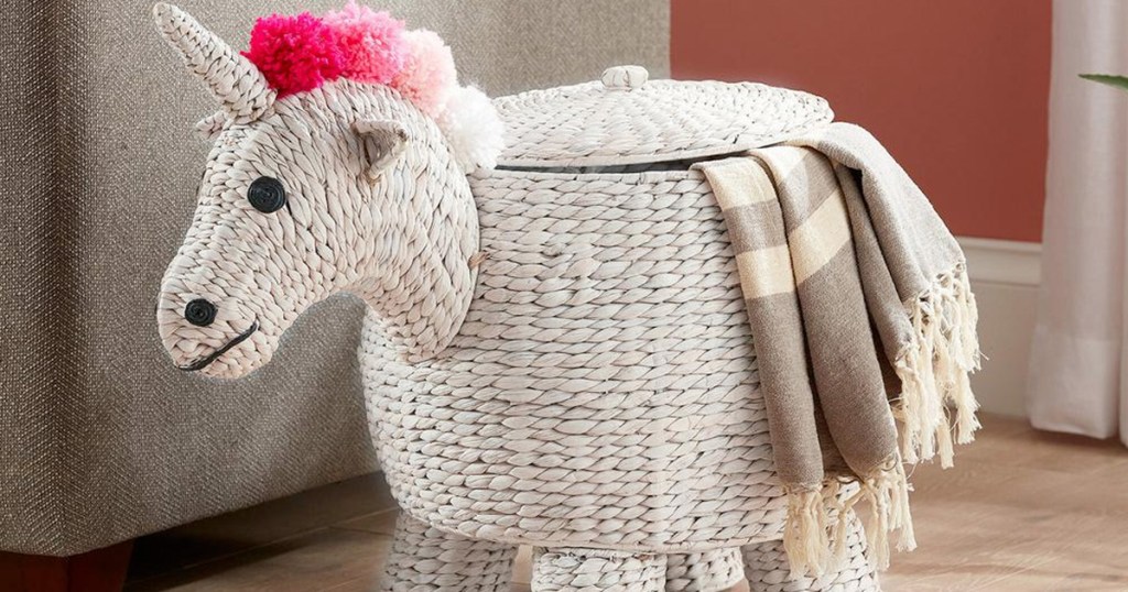 white unicorn sotrage basket with pink hair and blanket coming out from lid