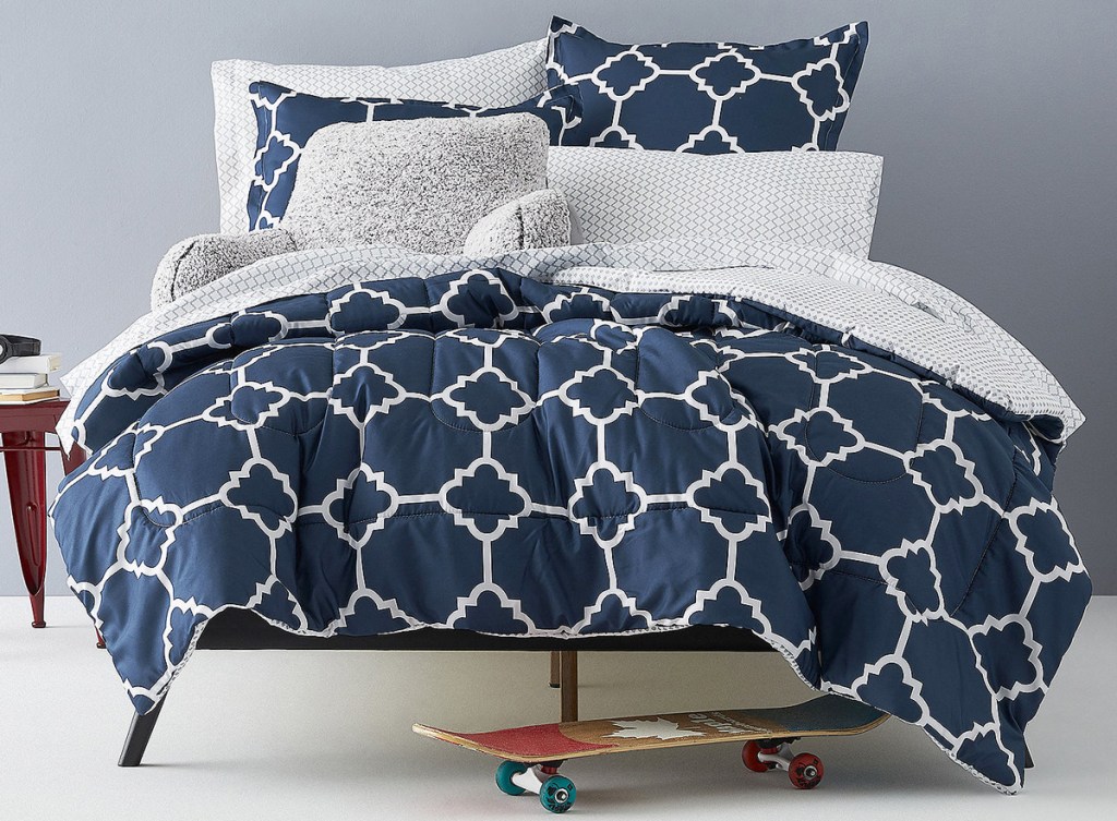 navy blue with white geographic print comforter on bed with matching pillow cases and shams