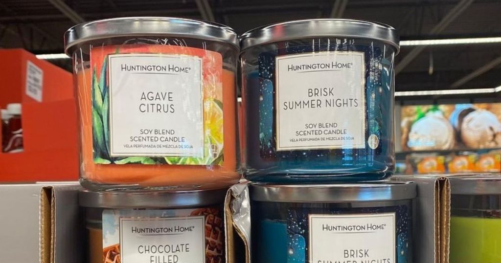 four jars candles on store shelf 