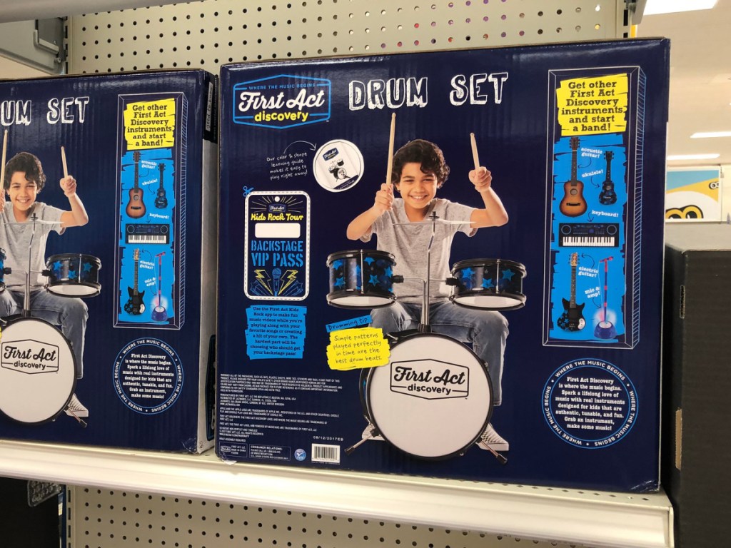 2 kids drum sets in boxes on a store shelf
