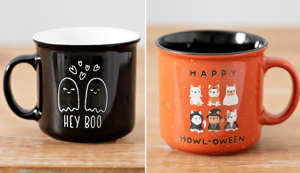 black ghost themed coffee mug that says "hey boo" and orange coffee mug with dogs in halloween costumes