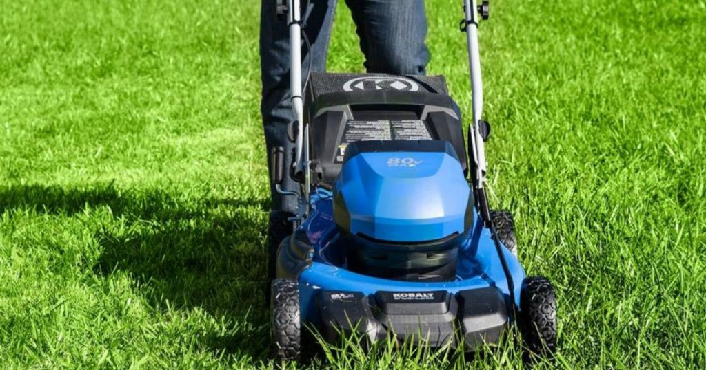 person pushing a lawn mower