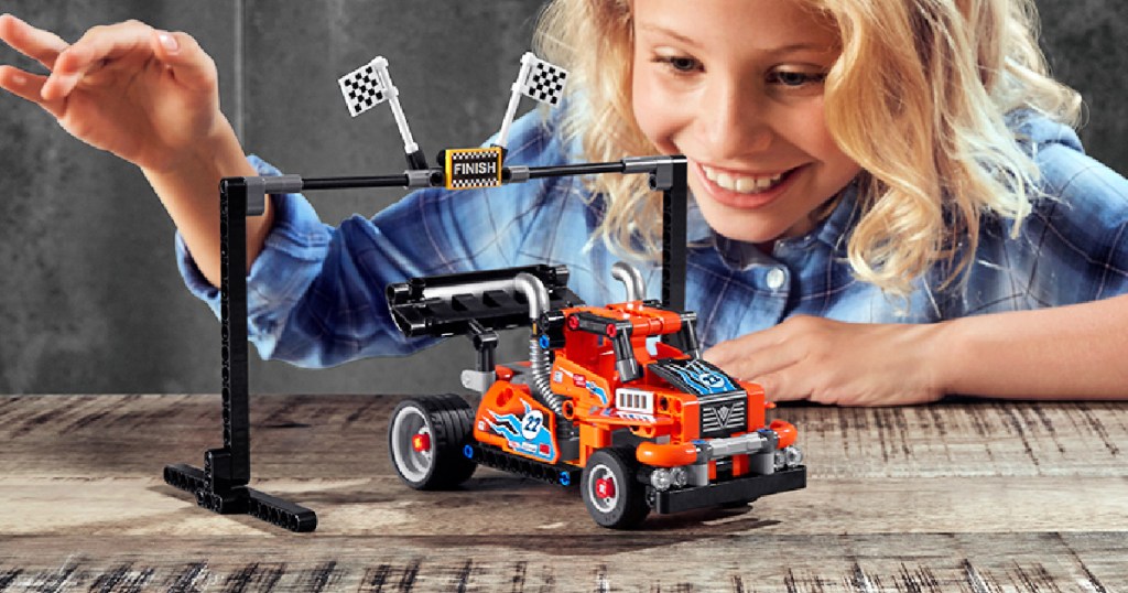 girl playing with LEGO Technic Race Truck 227-Piece Building Kit